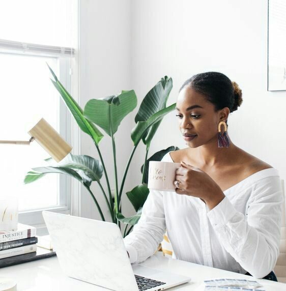A successful black business woman managing finances on her laptop